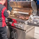 Chef Phillip Dell grilling hamburgers on a Bonfire Grill at the Back to Basics Grilling Class at BBQ Concepts of Las Vegas, Nevada