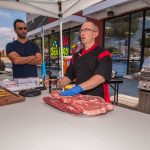 Chef Phillip Dell prepping meat — with Chef Phillip Dell at BBQ Concepts.