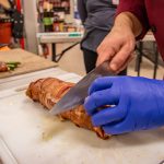 Cutting the Beautiful Bacon Wrapped Smoked Pork Tenderloin with Morello Cherry Sauce